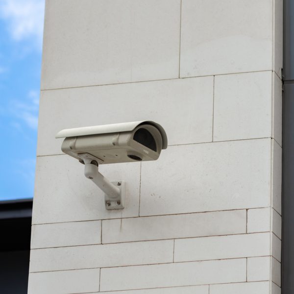 Surveillance camera built into the stone wall of the building, close up